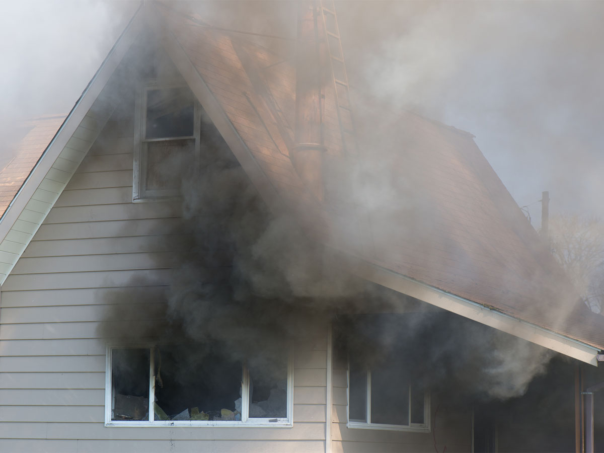 Smoke coming out of the windows of a home damaged by fire in Navarre, FL