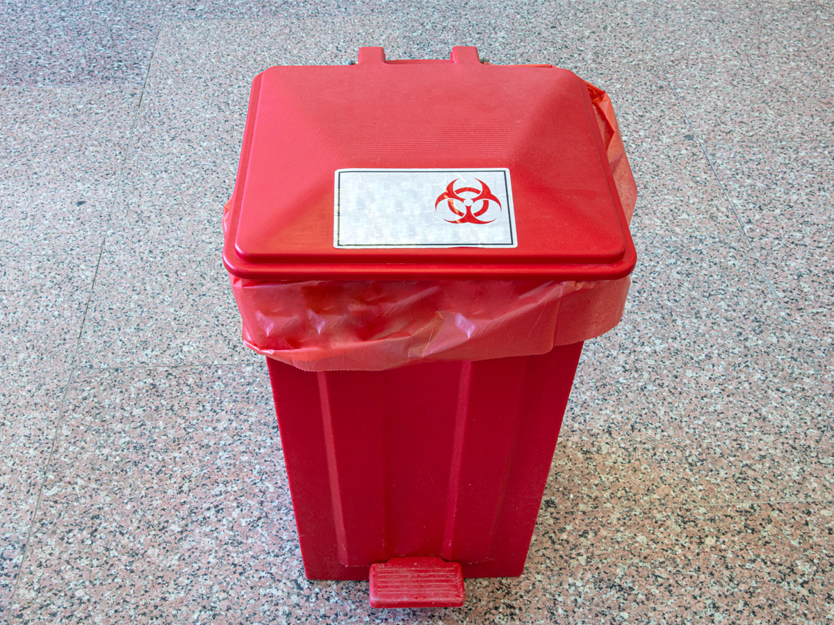 Biohazard cleanup in Fort Walton Beach, FL in a red biohazard waste bin